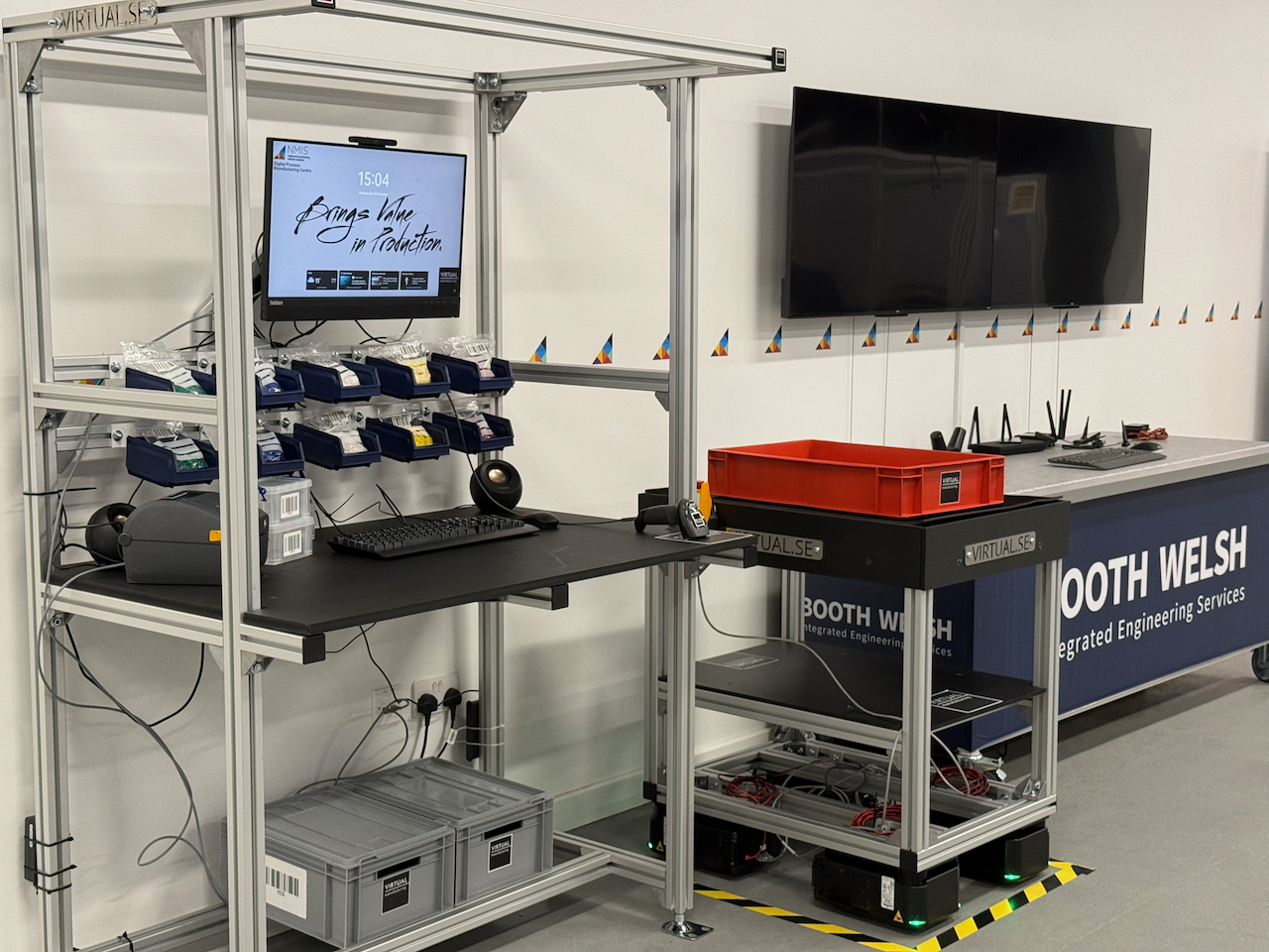 wheel.me autonomous wheel moving a mobile workstation in a factory, connected to a Tulip station displaying digital work instructions and real-time production data.