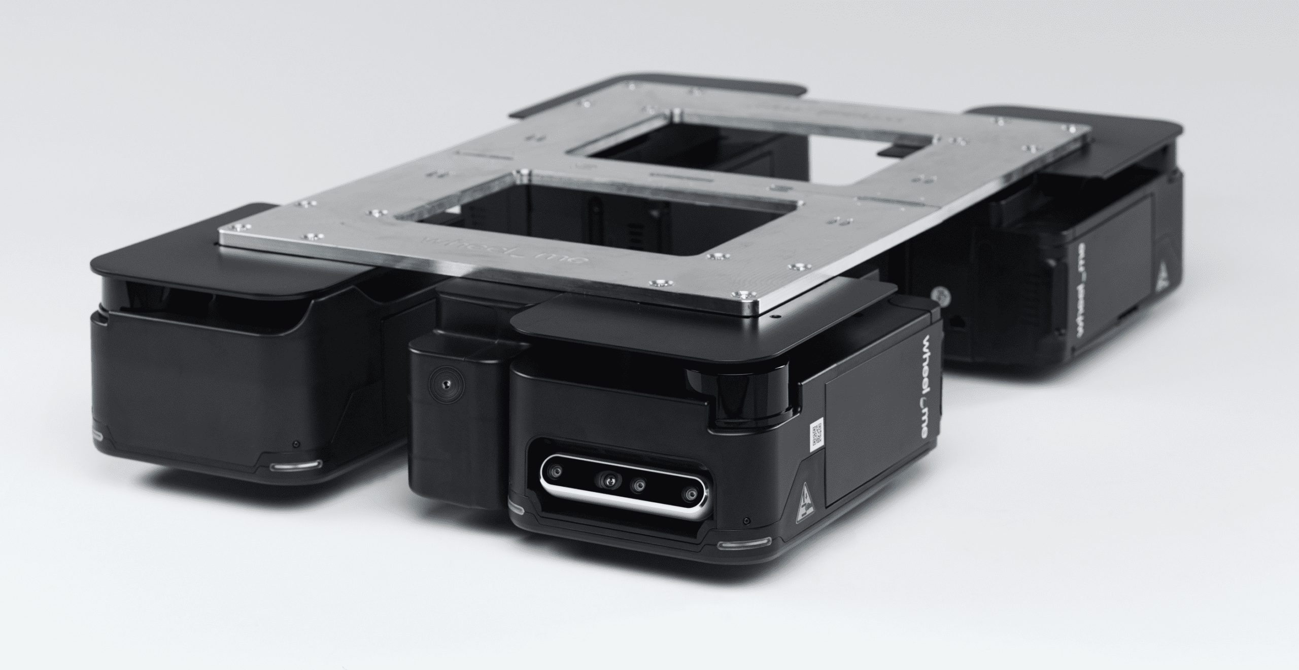 Four wheel.me autonomous drive wheels designed for mobile robots and flexible material handling in manufacturing environments.